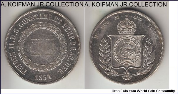 KM-465, 1854 Brazil (Empire) 1000 reis; silver, reeded edge; Pedro II, early and smaller mintage year of the type, extra fine or so details, but probably ex-jewelry as obverse has a spot in the center that looks like it was heavily de-solded.