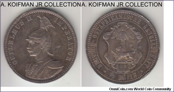 KM-4, 1897 German East Africa 1/2 rupie; silver, reeded edge; Wilhelm II, early type, scarce with small mintage of 75,000, especially so in high grades, almost uncirculated details with cabinet storage proof like toning, rim bump and what appear to be a flan defect across rim on obverse.