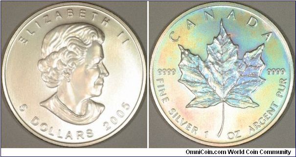 Silver maple leaf. We find it very difficult to get good photographs of some coins, Canadian maples, in all metals, are one of the most difficult, as they have striations on their surface, which is also slightly concave. We managed to get this photo by the simple action of breathing on it. It does give the coin a matt finish, but at least we got a reasonable picture.