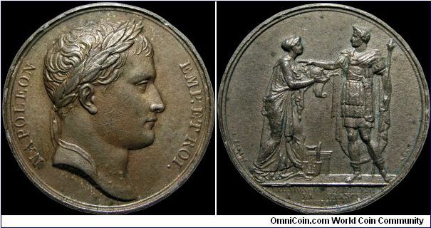 Réunion de l'Etrurie a l'Empire, France.

This is an example of the evils of cleaning coins. The French medals of this period (Paris mint) were coated with an artificial patina, essentially painted a chocolate brown. It has been harshly cleaned off this original medal leaving only bare metal underneath.                                                                                                                                                                                                  