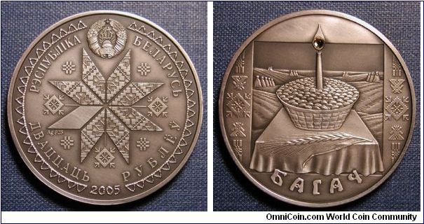 2005 Belarus 20 Roubles Bagach 
fine silver
content - 31.1 g;
alloy standard - 925; diameter - 38.61 mm
Mintage:
5000 pcs
(with inset of synthetic crystal of yellow color within the flame of the candle on silver coin) Oxidized