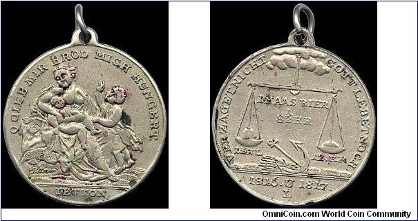 Famine medal, German States.

A common medal that appears to be making a commentary on the cost of food and where the balance lies. The obverse translates roughly to O God give me bread I'm hungry. There was terrible famine in the years 1816 and 1817.                                                                                                                                                                                                                                                       