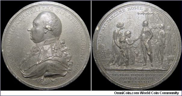 Defeat of Sultan Tipoo, Great Britain.

A white metal medal that was probably lacquered in the past. This results 200+ years later in this very dark patina. BHM says in part ' 
Cornwallis, aided by the Mahrattas and Nizam of Hyderabad defeated Tipoo and made him surrender half of his possessions in addition to paying an indemnity of 3030 lakhs of rupees and giving his two sons as hostages.'                                                                                                        
