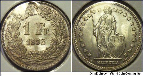 Switzerland 1952 1 franc. Blasting white, probably an excellent UNC grade here. A little carbon spot is visible at the upper top left crest in the obverse, otherwise, an excellent coin. Sold! $6.00