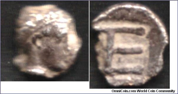 Worlds first denominated coin? Very small (7mm) silver Tetartemorion from Kolphon, Ionia. Obverse shows laureate bust of Apollo. Reverse shows TE monogram.