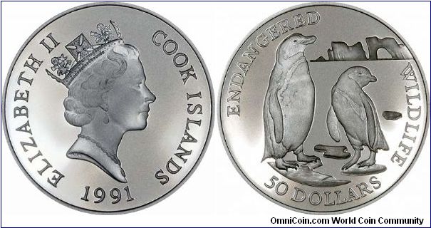 Jackass penguins on reverse of this silver proof $50 crown sized coin, with an Endangered Wildlife theme, part of a large series produced by Cook Islands.