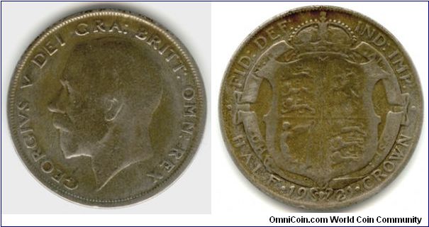 A Half Crown from 1921. On the reverse the coats of arm of England, Scotland and Ireland.