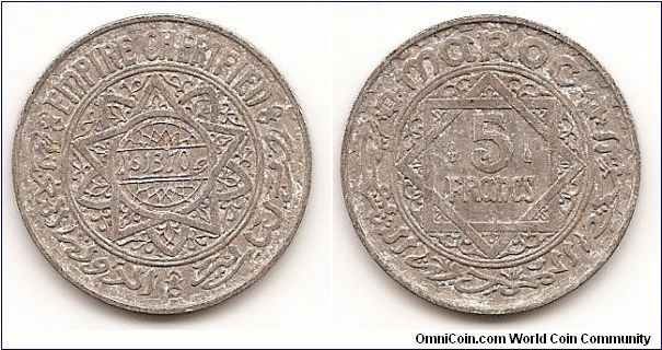 5 Francs
Y#48
Aluminum, 25 mm. Obv: Date within small circle of doubled trilobe
star, all within circle Rev: Value flanked by marks in doubled
square within circle