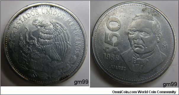 Stainless steel, 23.5mm.
SUBJECT: Benito Juarez
Obverse- National arms, eagle left. Reverse- Bust 1/4 with diagonal value at left. Edge Plain. 
50 Pesos