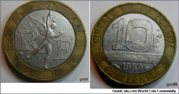 (found on the ground 12/12/2007)
Aluminum-Bronze Ring, Steel Center 10 Francs (1989)
Obverse- Legend on outside ring, value and date on center plug, three sets of criss-crossing lines 
LIBERTE EGALITE FRATERNITE 10F 1989 
Reverse- R F on center plug, winged fiugre with star on head carrying torch between 
R F