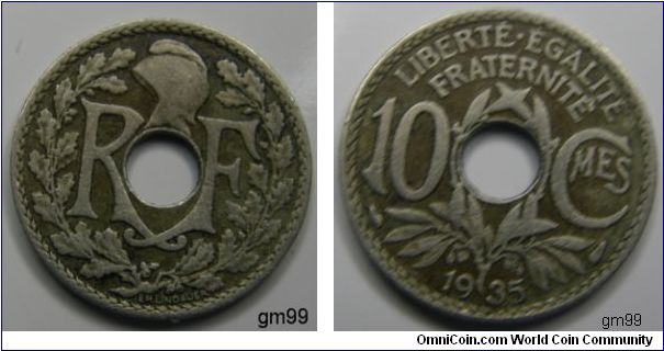 10 Centimes (Copper-Nickel) Obverse; Letters within wreath, either side of hole,
R F
Reverse; Wreath below and between value,
LIBERTE EGALITE FRATERNITE 10 CMES date 1935