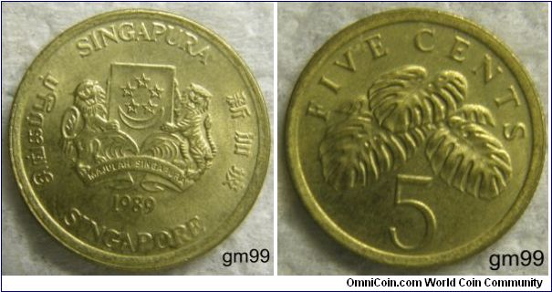 5 Cents.OBVERSE: Arms, 5 stars in circle above crescent on shield, a lion on left and tiger on right, below motto MAJILAH SINGAPURA,
SINGAPURA MAJULAH SINGAPURA date SINGAPORE
REVERSE: Fruit Salad plant above 5,
FIVE CENTS 5