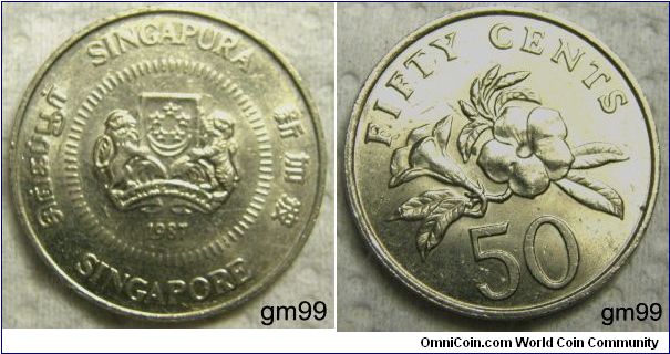 50 CENTS. Arms, 5 stars in circle above crescent on shield, a lion on left and tiger on right, below motto MAJILAH SINGAPURA,
SINGAPURA MAJULAH SINGAPURA date SINGAPORE. REVERSE: TWENTY CENTS, PLANT, 50