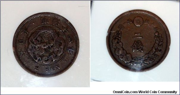 This is a 2 sen piece from the Meiji period. It has been graded be ngc.