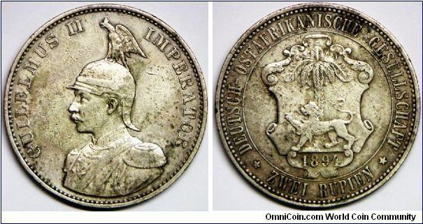 German East Africa, Colonial, Wilhelm II (1888 - 1918), 2 Rupien (Zwei Rupien), 1894 (Scarce date). 23.3200 g, 0.9170 Silver, .6872 Oz. ASW.  Obverse: Draped bust l. of Wilhelm II with helmet. Reverse: Shield of arm: before date palm, lion. Mintage: 18,000 units. VF. Rare.