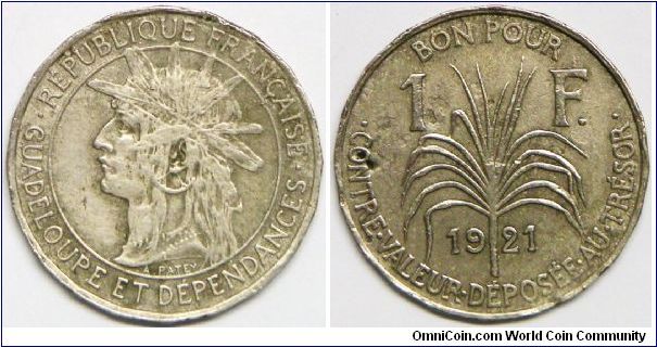 French Colony (1816 - to date) - Guadeloupe, 1 Franc, 1921. Copper-Nickel. Obv: Armored head left within circle. Rev: Sugar cane stalk divides date and domination. Shape: 20-side. Mintage: 700,000 units. About EF.