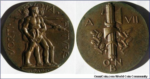Italian Fascist Medal.
SORTI DEVOTA  FUTURAE  Rev: A VII O.N.B.  by Papi for Lorioli  Castelli  Bronze 41mm
Opera  Nazionale Balilla (ONB) was an Italian Fascist youth organization. Created through Mussolini's decree of April 3 1926 this is A VII for year 7.
It was named after Balilla (Giovan Battista Perasso), a semi-legendary Genoese character who started the local revolt of 1746 against the Austrian Habsburg forces that occupied the city in the War of Succession.