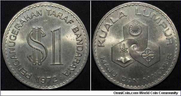 Copper-Nickel, 33.5mm Subject: Kuala Lumpur Anniversary Obv: Artistic value and dollar sign above date Rev: Artistic design, MALAYSIA BANK NEGARA. Mintage: 500,000.