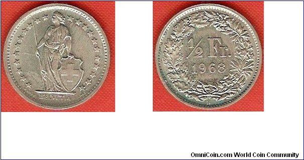 1/2 franc
coin alignment
22 stars around figure of Helvetia
copper-nickel