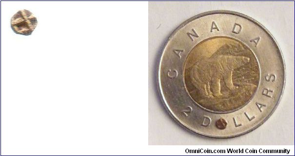 11th to 13th century Indian gold 1/10 fanam coin. 2 mm diameter. (same size as the O in DOLLARS on a Canadian toonie)