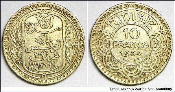 French Protectorate (1881-1955), Ahmad Pasha Bey (1929-1942), Decimal coinage, 10 Francs, AH1353/1934a. 10g, 0.6800 Silver, .2186 Oz. ASW. Obv.: Inscription within oblong design flanked by sprigs. Obv. Legend: AHMAD. Rev.: Value and date within center circle of design. Mint: Paris. Mintage: 30,000 units. VF+ to EF. This coin is undervalued in Krause.