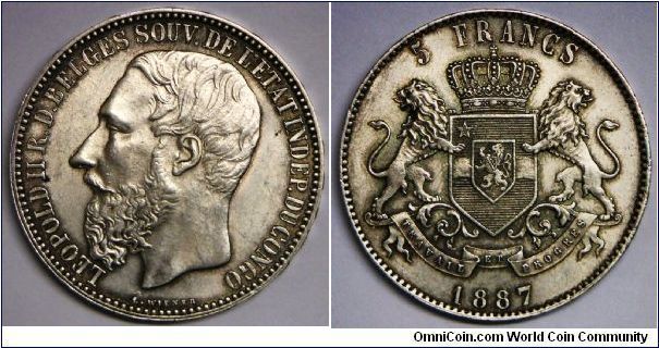 Belgian Congo silver 5 Francs, 1887. King Leopold II of Belgium owned the Belgian Congo as his personal territory. There was no attempt to rule democratically/fairly. This was probably the most egregious example of selfish colonialism in all of the African colonies. Leopold was forced, by world opinion, to cede the colony to the Belgian government in 1908, who actually did a decent job in eradicating disease, educating the populace and bringing in modern railroads & ports. BU. Rare. 
