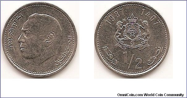 1/2 Dirham -AH1407-
Y#87
Copper-Nickel Obv: Head left Rev: Crowned arms with supporters