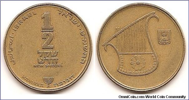 1/2 New Sheqel -JE5749-
KM#174
6.5000 g., Aluminum-Bronze, 26 mm. Subject: Hanukka Obv: Value Rev: Lyre Note: Coins dated JE5754-5768 have the Star of David mint mark; the coins dated JE5747-5753 do not