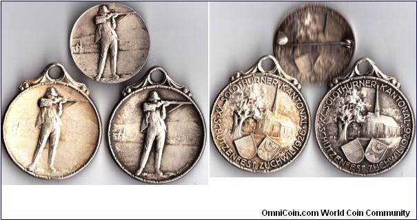 two different swiss shooting medals issued for the festival at Zuchwiil in Solothurn 1926. The first type was issued for suspension. The second is smaller and more like a jeton. This example has been made into a badge.