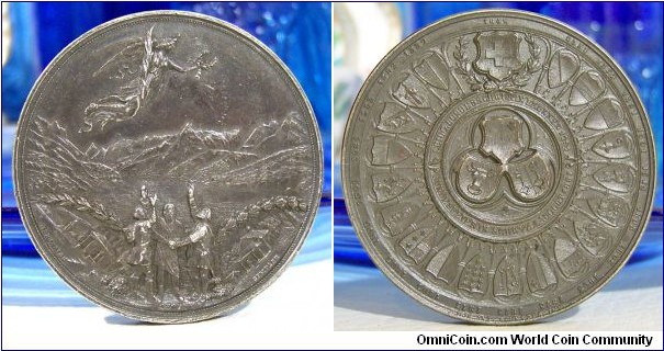 1891 Swiss Confederation 600th Anniversary, Battles Morgarten Sempach & Coat of Arms Cantons Medal. Silver 50MM/45.2 gm
Obv: Delegates of three original Cantons swear Oath of Rutli before lake Lucerne & mountains. Rev: Arms of all 23 Cantons with date of joining Confederation.

