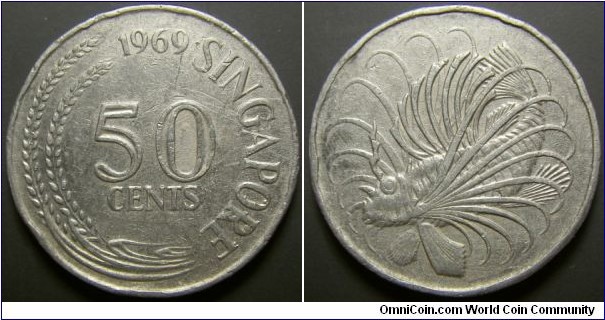 Singapore 1969 50 cents counterfeit. Quite odd. Weight: 8.13g which is about more than 1g less than the usual 50 cent coins. 