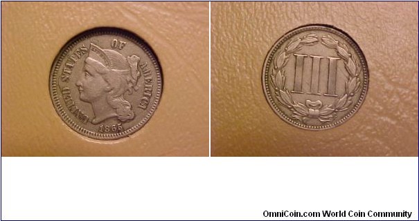 A first-year example of the 3-cent nickel, which was minted contemporaneously with the 3-cent silver from 1865-73.