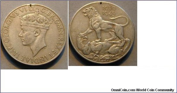 1939-1945 Great Britian War Medal. 36MM. Awarded to all full time personal of the armed forces & merchant marines.
Obv: Depicts the crowned head of King George VI with the legend GEORGIVS VID;G.BR:REX ET INDIAE IMP. Rev: A vivtorious lion standing on a defeated 2 headed dragon (the axis powers) with the dates 1939-1945 above.
